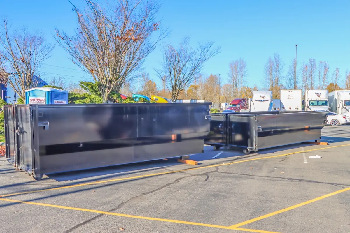 Professional dumpster rental service with roll-off container on residential driveway in Murphy